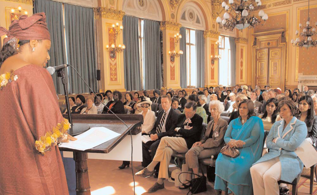 Eleanor Nwadinobi from Widows Development Organisation (WiDO) speaking at the Conference. Delegates include Cherie Booth QC, Shamin Lalji and Yoko Ono.